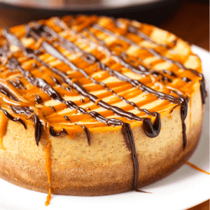 close up of a whole pumpkin cheese cake on a large plate