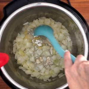 stirring and cooking onion and garlic in the instant pot