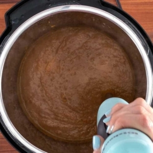 using an immersion blender to puree pumpkin soup in the instant pot