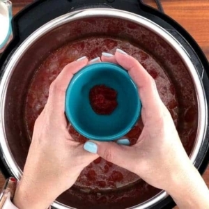 adding tomato paste to tomato soup