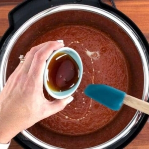 adding honey to tomato soup