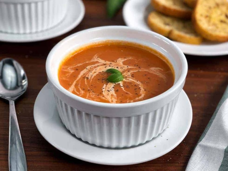 a bowl of instant pot tomato soup with basil