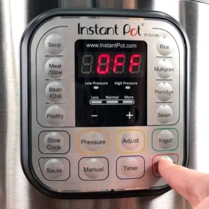 turning off the instant pot after the tomato soup has finished cooking