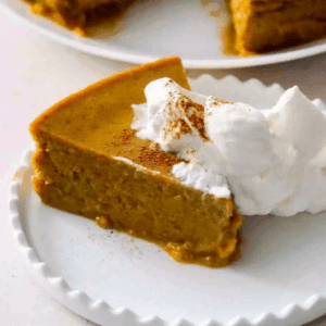 a slice of pumpkin pie with whipped cream on it