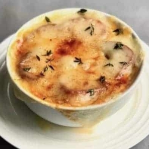 french onion soup in a bowl centered on a plate