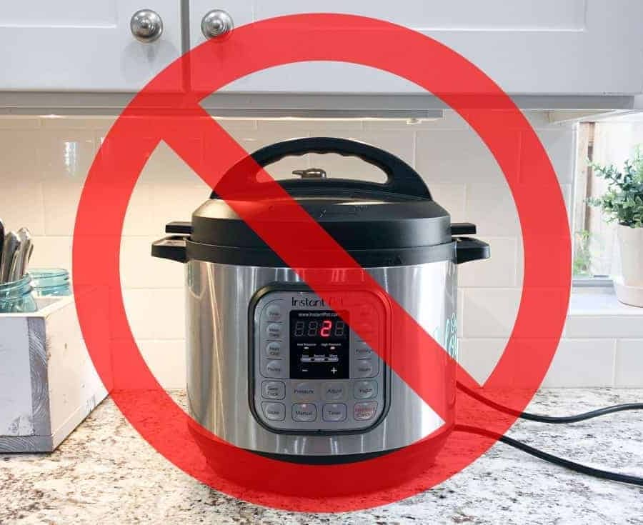 an instant pot placed under a cabinet