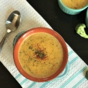 overhead shot of broccoli cheddar soup in a small bowl