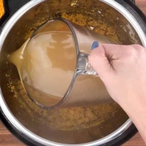 adding chicken stock to the instant pot