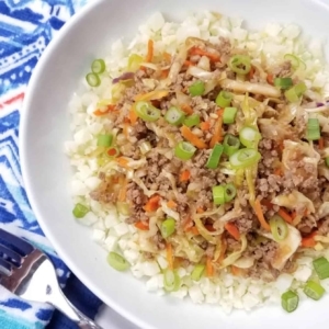 egg roll in a bowl garnished with scallions