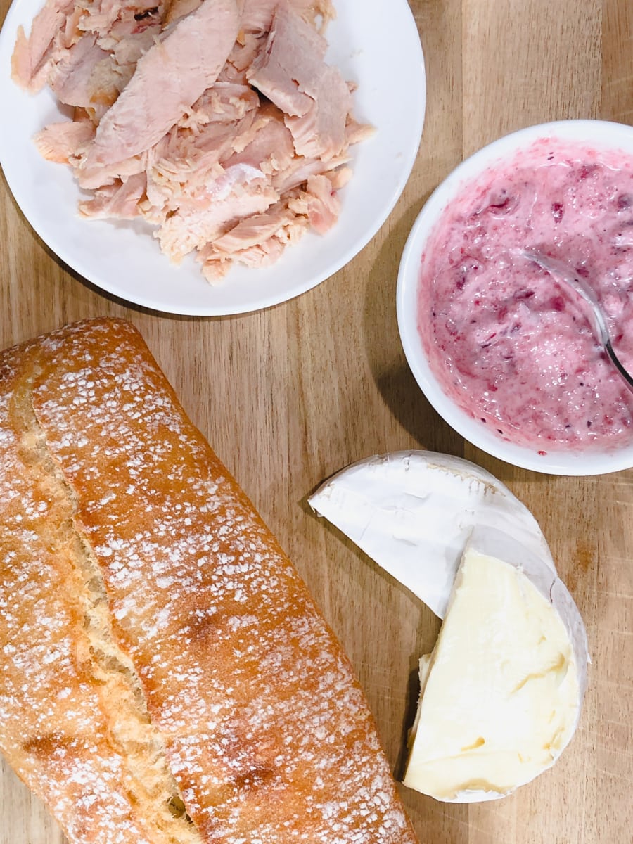 overhead shot of bread, turkey, brie and cranberry aioli