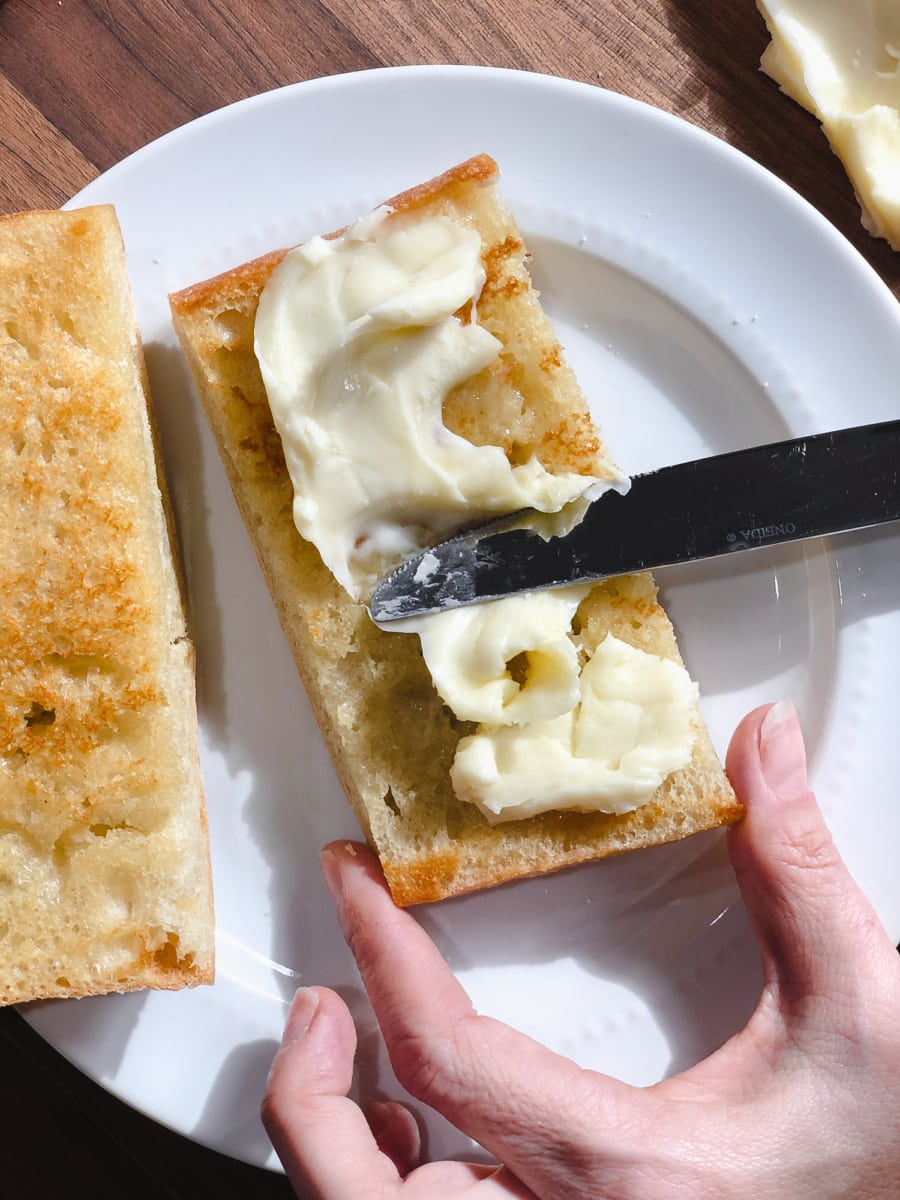 spreading brie on ciabatta bread