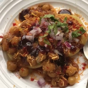 overhead shot of ragda patties on a plate garnished with cilantro