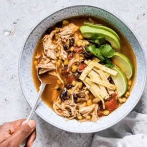 overhead shot of chicken tortilla soup in a bowl with a spoon