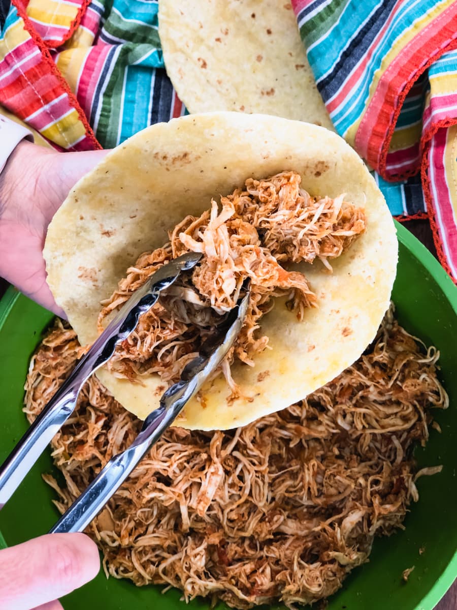 serving salsa chicken on a tortilla