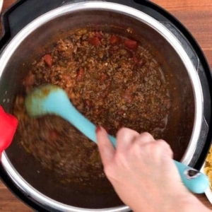 seasoning the ground beef for taco pasta