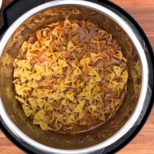 bowtie pasta, taco flavored ground beef, and beef broth in the instant pot