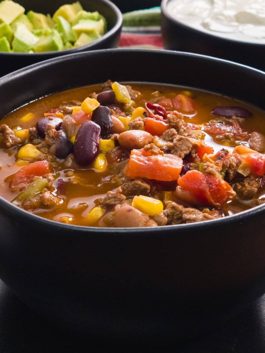 an amazingly flavorful bowl of taco soup loaded with beans, ground beef, tomatoes, green chilis, and corn