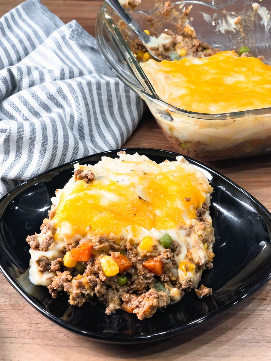 a plate of shepherds pie on a wooden table