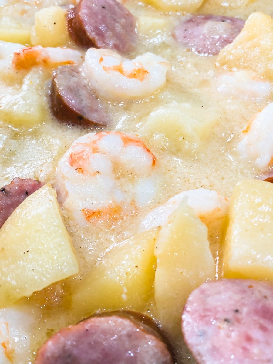 a close up of sausage and potatoes with shrimp