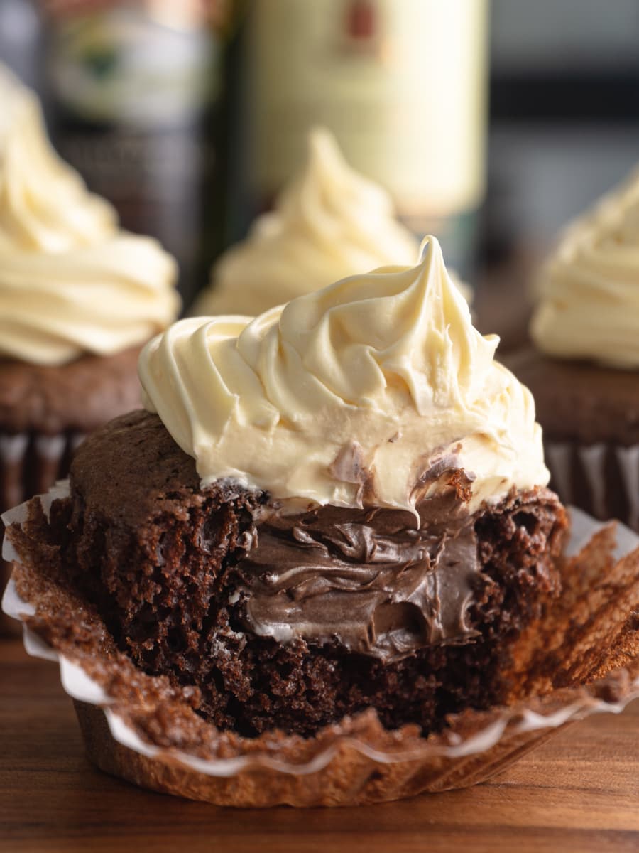 an irish car bomb cupcake cut in half revealing the whiskey chocolate filling inside