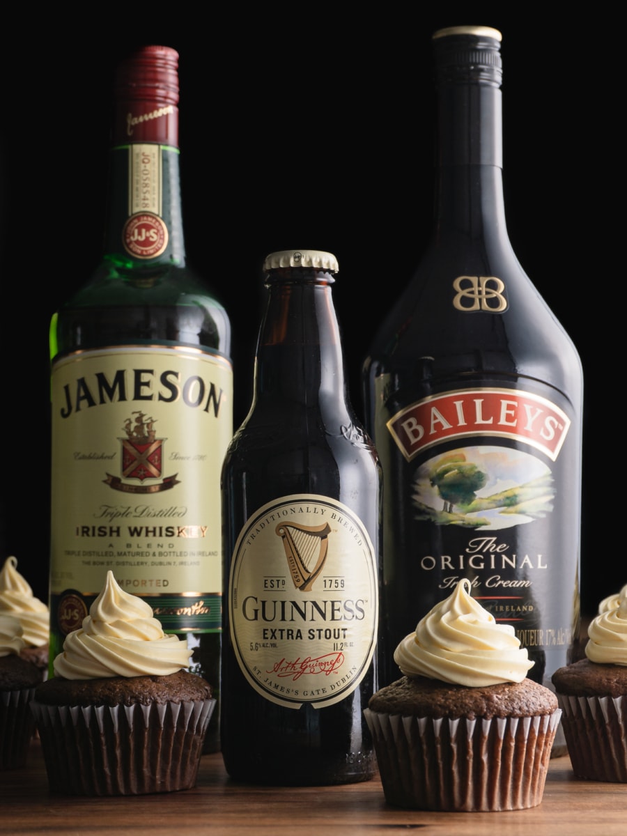  irish car bomb cupcake next to a bottle of guinness and irish whiskey