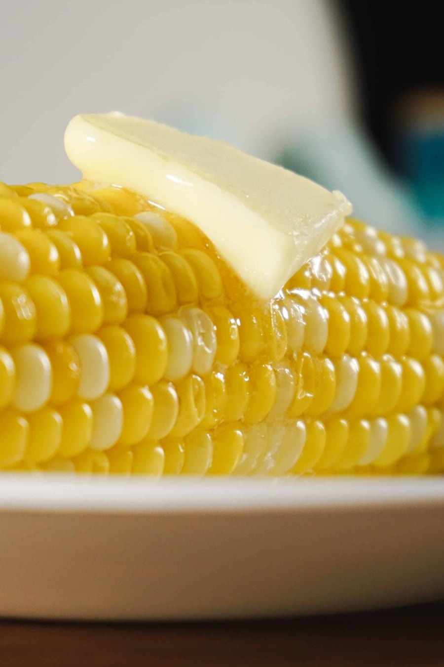 corn on the cob with a slice of melting butter sitting on top
