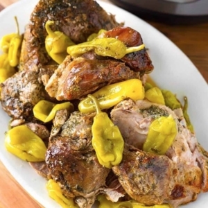 mississippi pork on a large plate with banana peppers