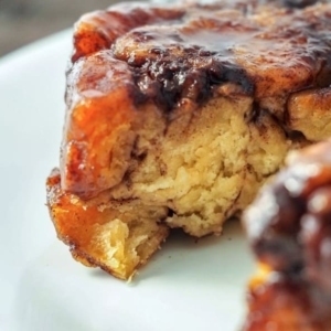 close up of glossy monkey bread on a plate