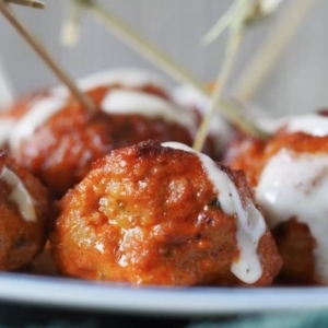 close up of glossy buffalo meatballs on a plate