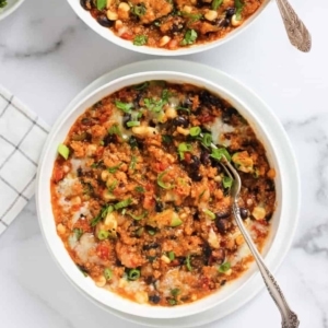 overhead shot of bowls of chicken enchilada quinoa