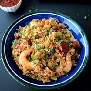 a large bowl of jambalaya garnished with cilantro