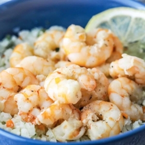 close up of shrimp scampi in a bowl of rice