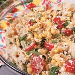 a large bowl of street corn pasta garnished with cilantro