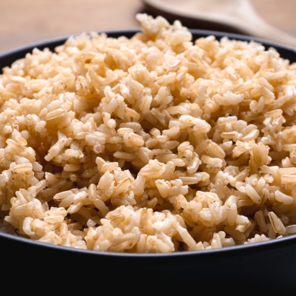 side view of brown rice in a bowl