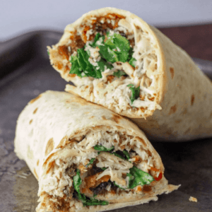 close up of chicken caesar salad wraps on a tray