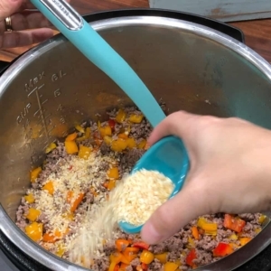 adding mince onion to season ground beef