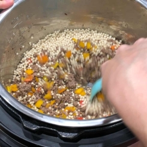 stirring the pearl couscous in the instant pot