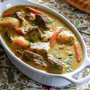 a large serving bowl of indian beef curry