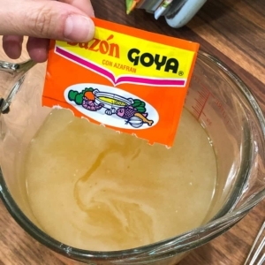 adding goya seasoning to chicken broth