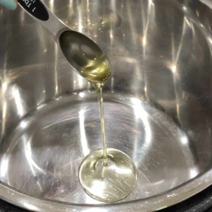 adding olive oil to saute chicken in an electric pressure cooker