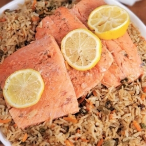 salmon rice pilaf in a bowl garnished with lemon slices