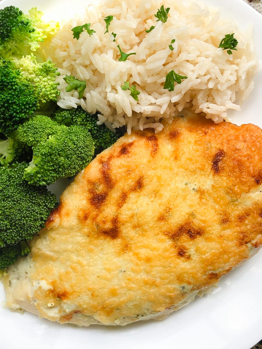 creamy salsa verde chicken bake served on a plate with rice and broccoli