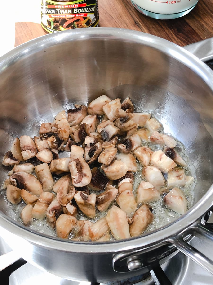 Sauteed mushrooms in a large pot