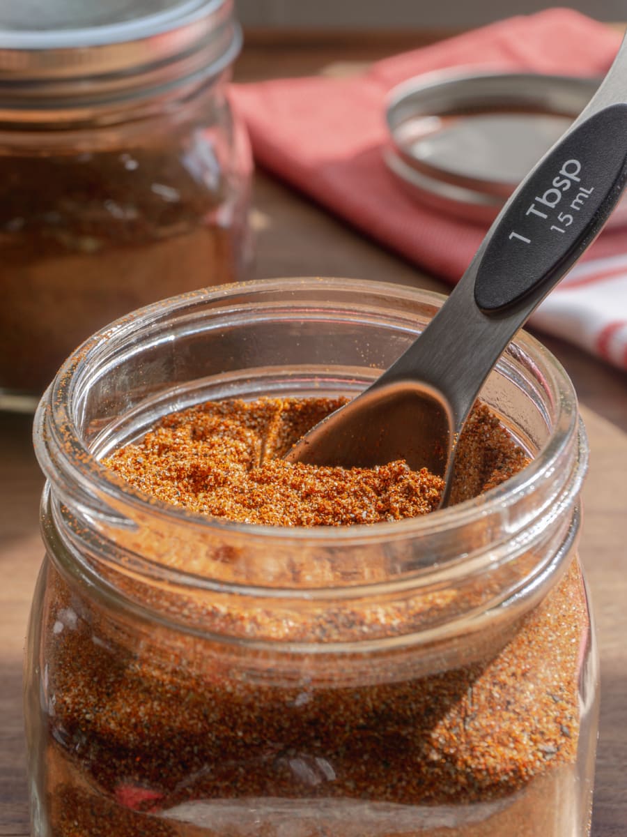 close up of homemade taco seasoning in a clear jar