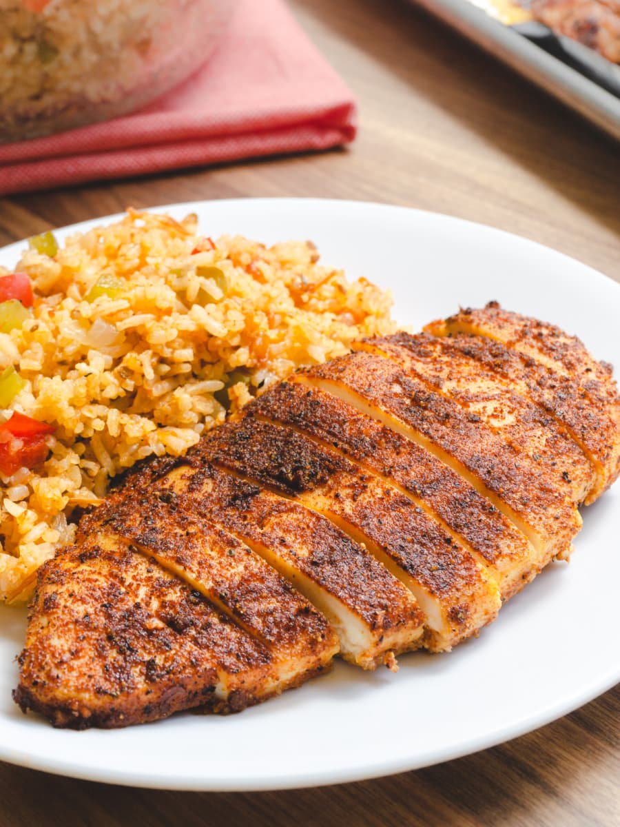 oven-baked mexican chicken breast on a plate with rice