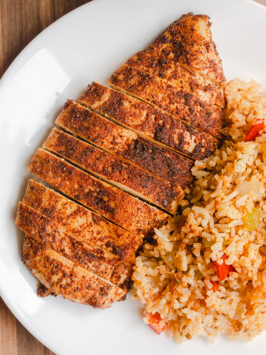 overhead shot of a plate with a sliced oven-baked chicken breast