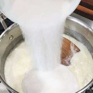 adding sugar to melted butter