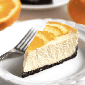 creamy and soft orange cheesecake on the center of a plate