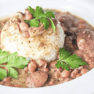 red beans and rice with sausage in a large bowl garnished with cilantro