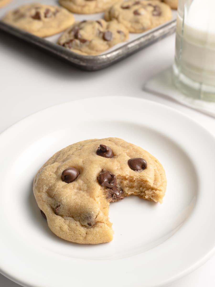 a freshly made chocolate chip cookie with a bite taken out of it